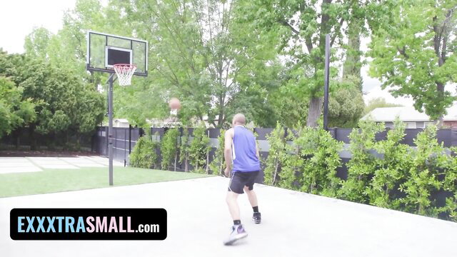 Bald man in tank top shorts dribbles basketball on outdoor court ExxxtraSmall